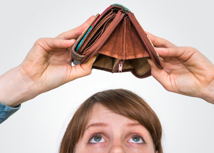 Business woman holding an empty wallet, she hasn't money