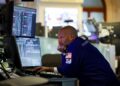 FILE PHOTO: A trader works on the floor at the New York Stock Exchange (NYSE) in New York City, U.S., July 7, 2025. REUTERS/Jeenah Moon/ File Photo