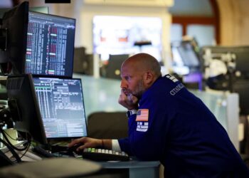 FILE PHOTO: A trader works on the floor at the New York Stock Exchange (NYSE) in New York City, U.S., July 7, 2025. REUTERS/Jeenah Moon/ File Photo