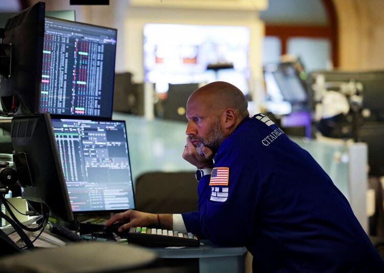 FILE PHOTO: A trader works on the floor at the New York Stock Exchange (NYSE) in New York City, U.S., July 7, 2025. REUTERS/Jeenah Moon/ File Photo