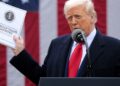 WASHINGTON, DC - APRIL 02: U.S. President Donald Trump holds up a copy of a 2025 National Trade Estimate Report as he speaks during a “Make America Wealthy Again” trade announcement event in the Rose Garden at the White House on April 2, 2025 in Washington, DC. Touting the event as “Liberation Day”, Trump is expected to announce additional tariffs targeting goods imported to the U.S. (Photo by Chip Somodevilla/Getty Images)
