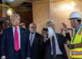 US President Donald Trump and Office of Management and Budget (OMB) Director Russell Vought (C) look on as Federal Reserve Chair Jerome Powell (2nd R) speaks with the construction manager as they tour the ongoing construction at the Federal Reserve in Washington, DC, on July 24, 2025. Trump arrived for a tour of the US Federal Reserve as the president escalates pressure on its chairman Jerome Powell over the central bank's management of the economy. Trump -- who wants to oust Powell for refusing to lower interest rates but likely lacks the legal authority -- has threatened to fire the Fed chief over cost overruns for a renovation of its Washington headquarters. (Photo by ANDREW CABALLERO-REYNOLDS / AFP) (Photo by ANDREW CABALLERO-REYNOLDS/AFP via Getty Images)