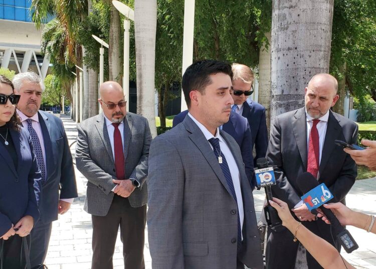Dillon Angulo, who was seriously injured in a Florida crash involving Tesla’s Autopilot driver assist technology, speaks to reporters outside the federal courthouse in Miami, Friday, Aug. 1, 2025.   (AP Photo/David Fischer)