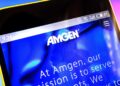(madamF/Shutterstock.com)
stock-amgen-05-shutter
Berdyansk, Ukraine - March 30, 2019: Amgen website homepage. Amgen logo visible on the phone screen, Illustrative Editorial.