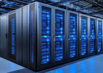 Large data center server room with rows of modern computer hardware illuminated by blue LED lights.
