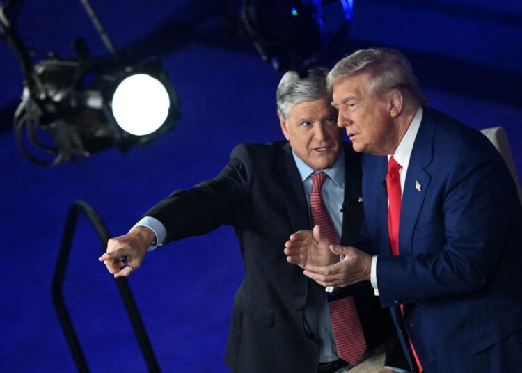 Former US President and Republican presidential candidate Donald Trump (R) chats with Fox News broadcaster Sean Hannity following a town hall at the New Holland Arena in Harrisburg, Pennsylvania, on September 4, 2024. (Photo by Mandel NGAN / AFP)