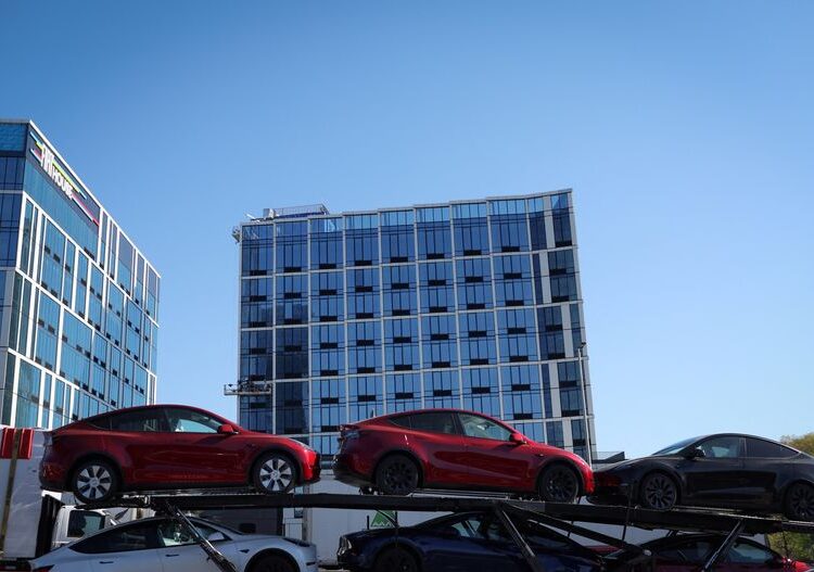 New Tesla vehicles are loaded on a car carrier in New York City, U.S., April 26, 2024. REUTERS/Mike Segar/File Photo