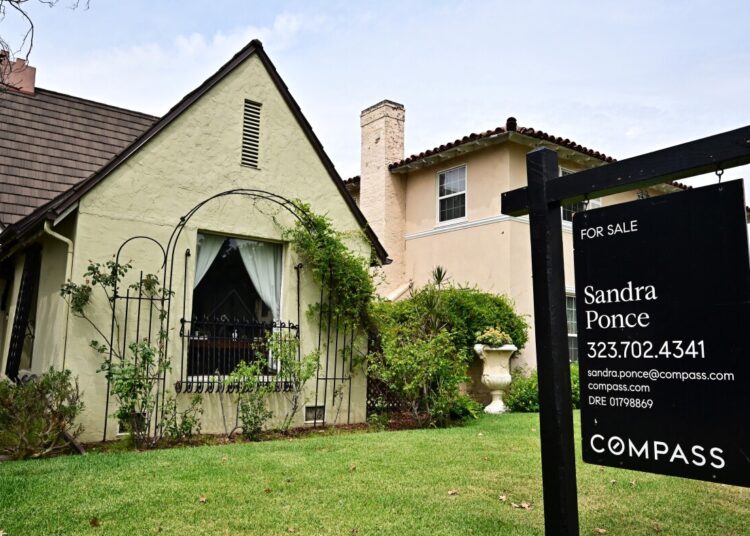 A 'For Sale' sign is posted beside property for sale in Alhambra, California, on August 28, 2025. Home sales across the country have slowed as interest rates remain a critical barrier to buyers with less than 30% of US homes now affordable for the typical US household, according to a Realtor.com report. (Photo by Frederic J. BROWN / AFP) (Photo by FREDERIC J. BROWN/AFP via Getty Images)