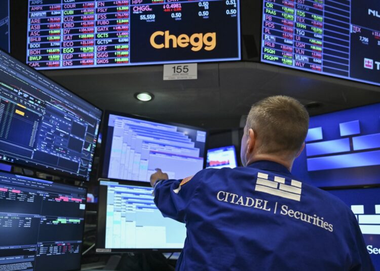A trader works on the floor of the New York Stock Exchange (NYSE) at the opening bell on April 21, 2025, in New York City, Wall Street stocks opened lower Monday amid lingering uncertainty over President Trump's trade policy as markets looked ahead to major earnings later in the week. China on Monday hit out at other countries negotiating trade deals with the United States at Beijing's expense, vowing countermeasures against those who "appease" Washington. (Photo by ANGELA WEISS / AFP) (Photo by ANGELA WEISS/AFP via Getty Images)